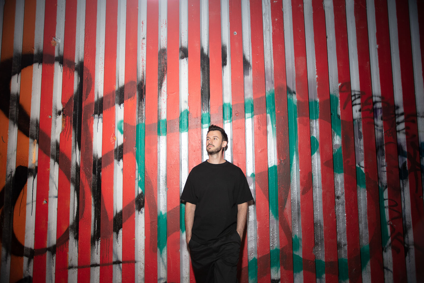 Bury in front of a red and white striped wall