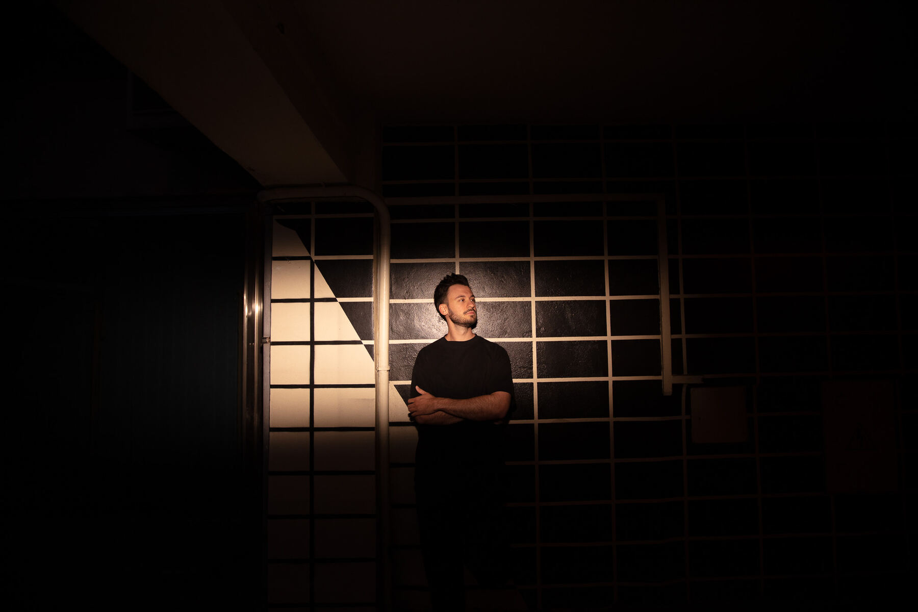 Bury in a spotlight against a grid wall